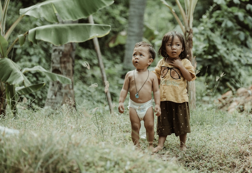 a couple of small children standing next to each other