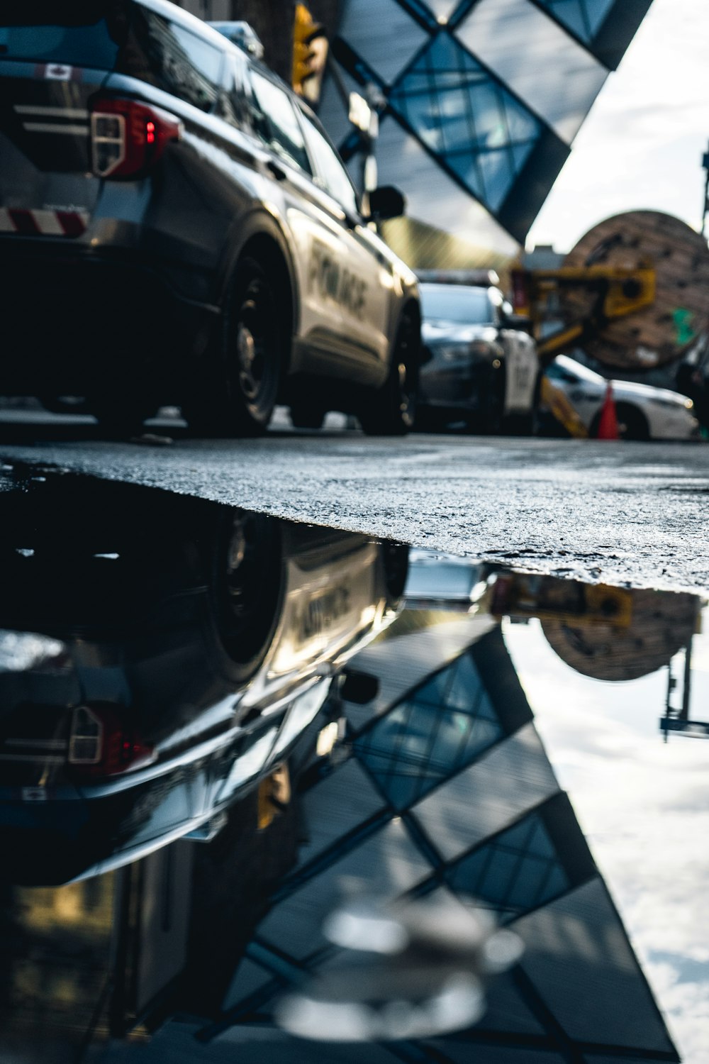 a reflection of a building in a puddle of water