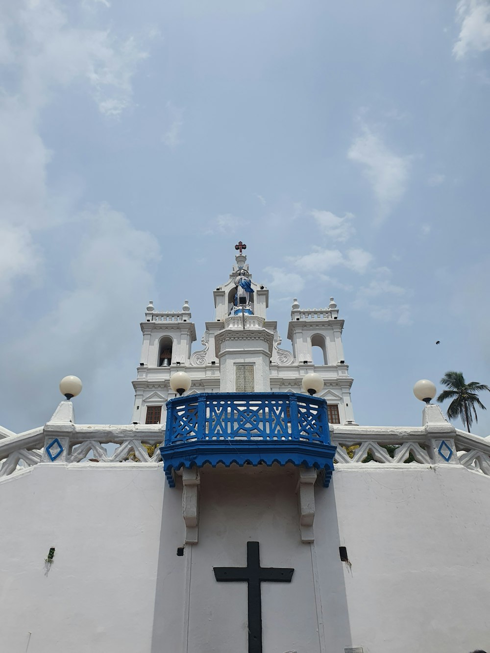 a large white building with a cross on the top of it