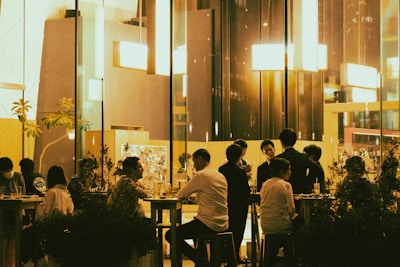 a group of people sitting at a table in a restaurant