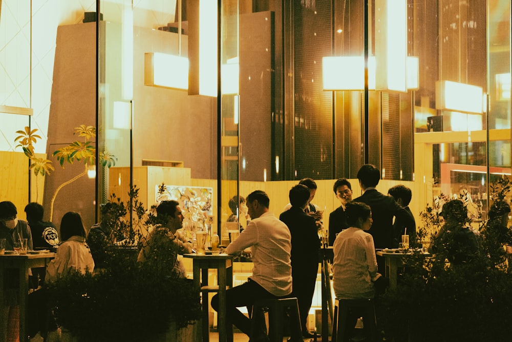 a group of people sitting at a table in a restaurant