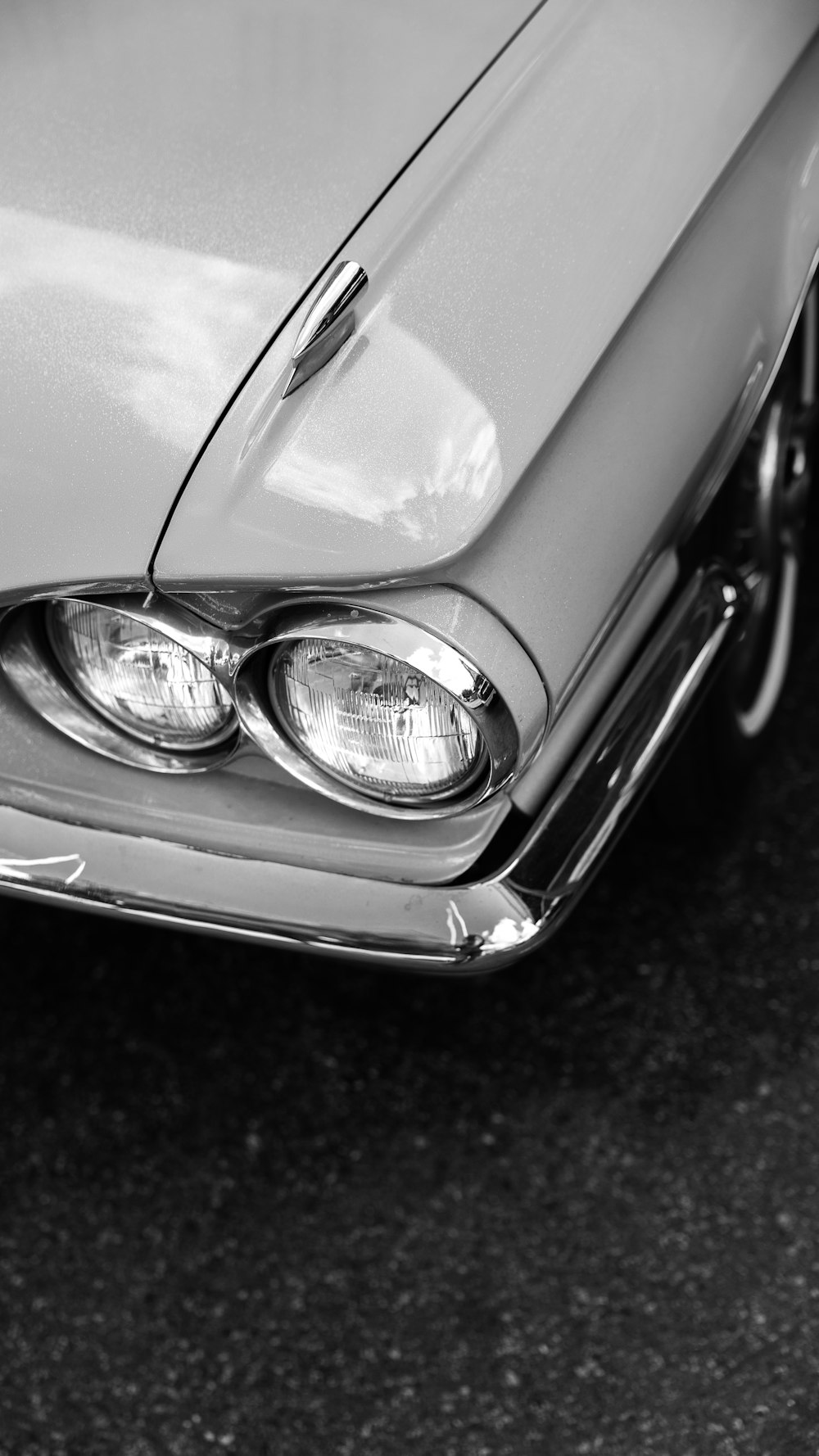 a black and white photo of a classic car