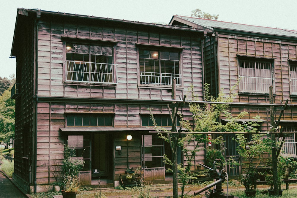 an old wooden building with a clock on the front of it