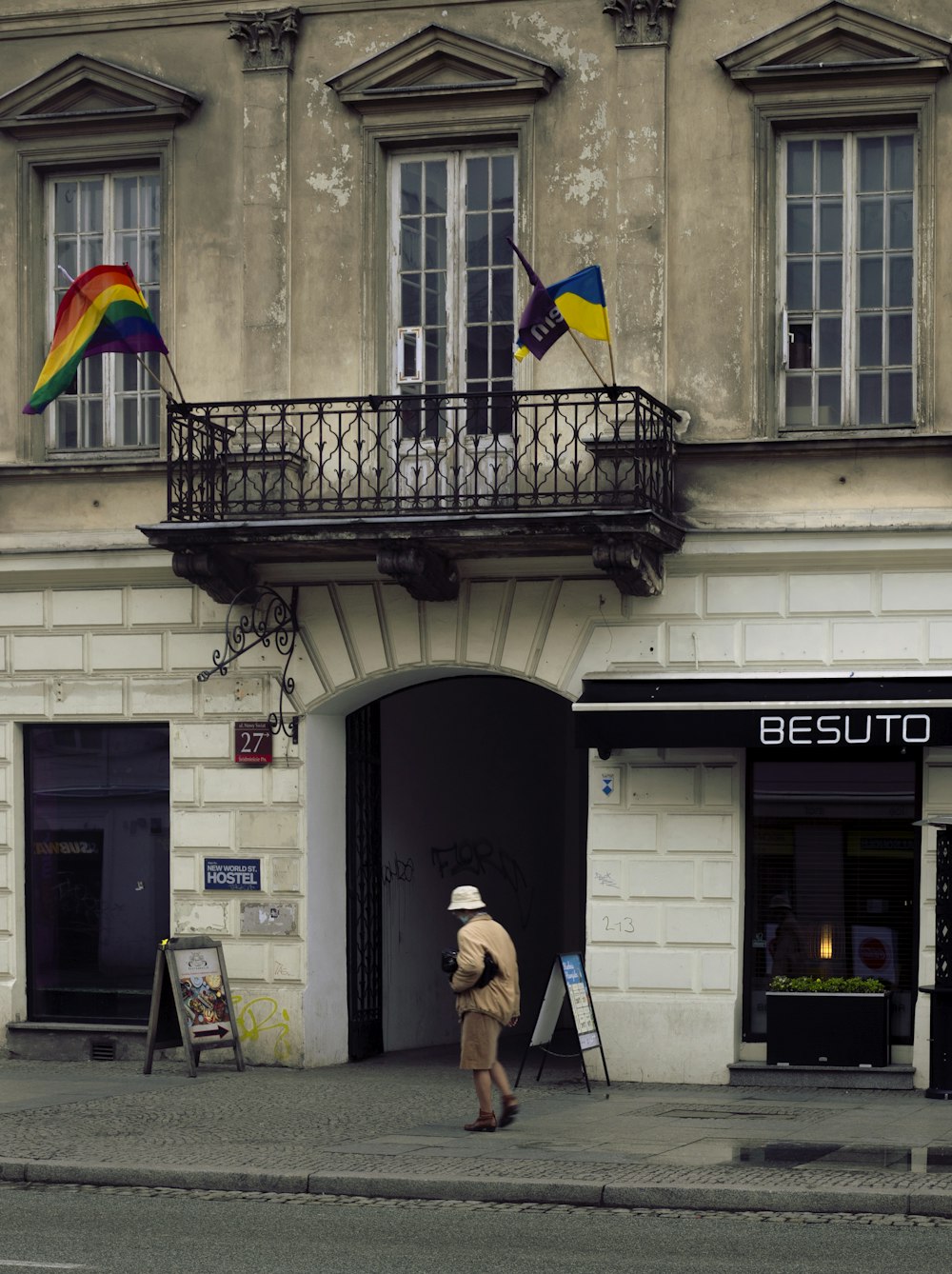 a man walking down the street in front of a building