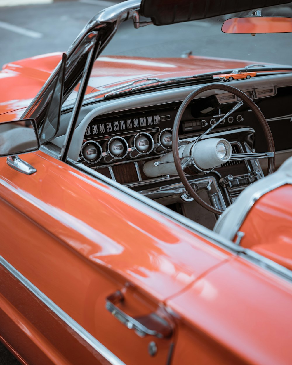 an orange car with a steering wheel and dashboard