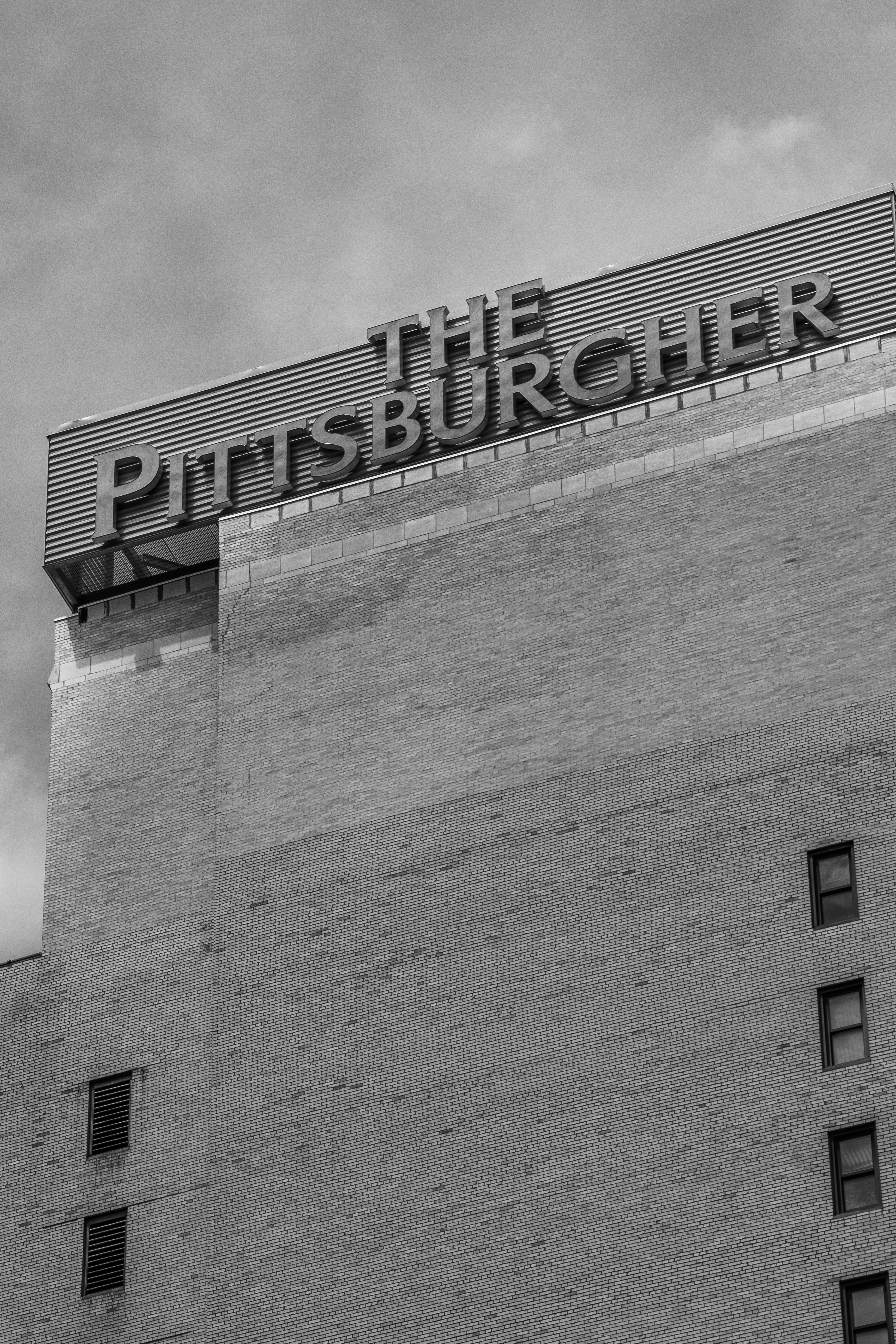 a black and white photo of a brick building