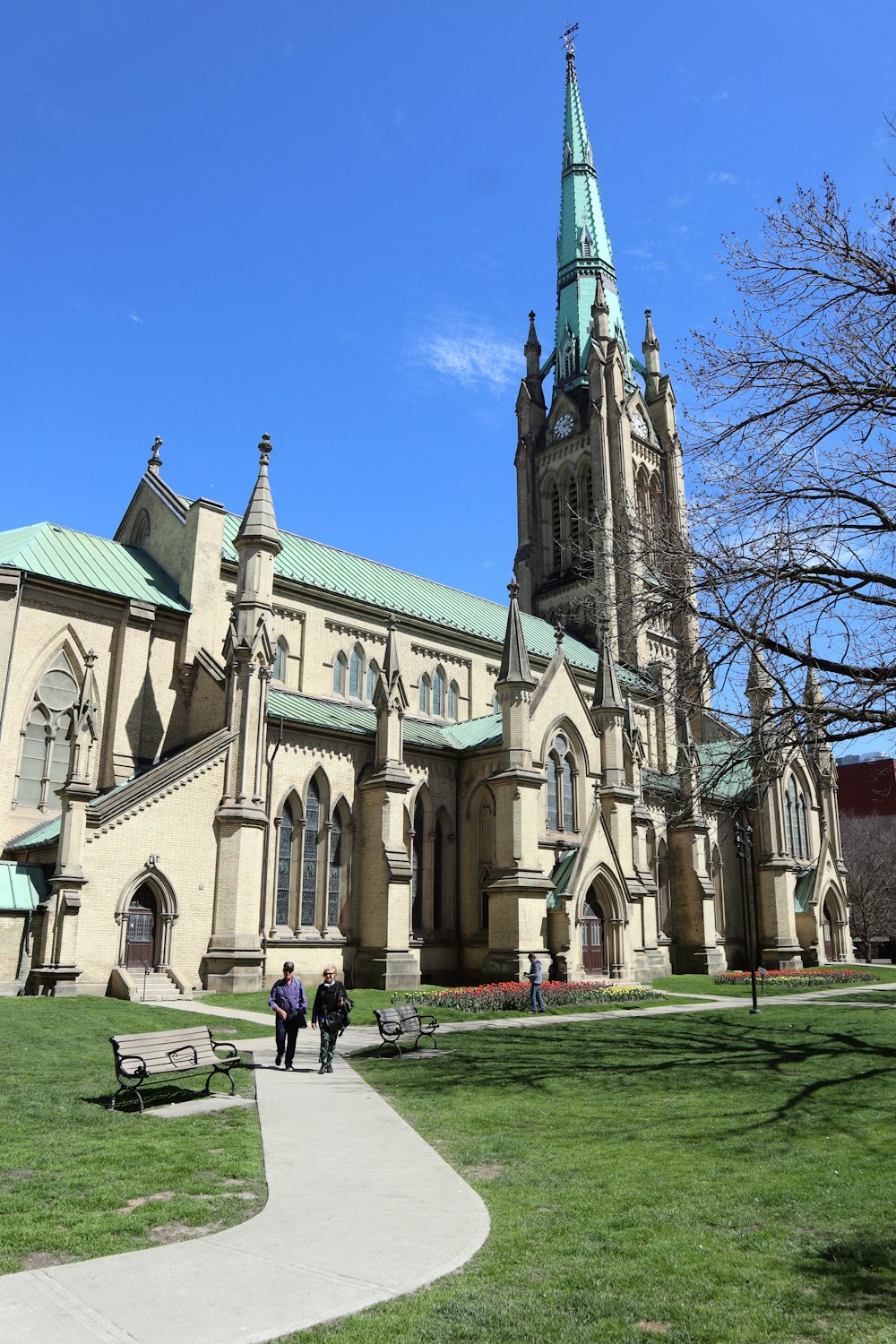 a large church with a green steeple on a sunny day