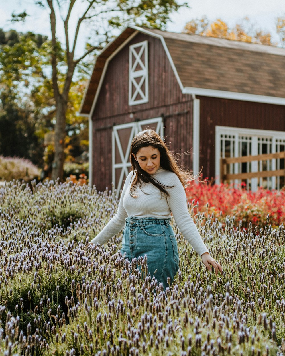 a woman standing in a field of lavender