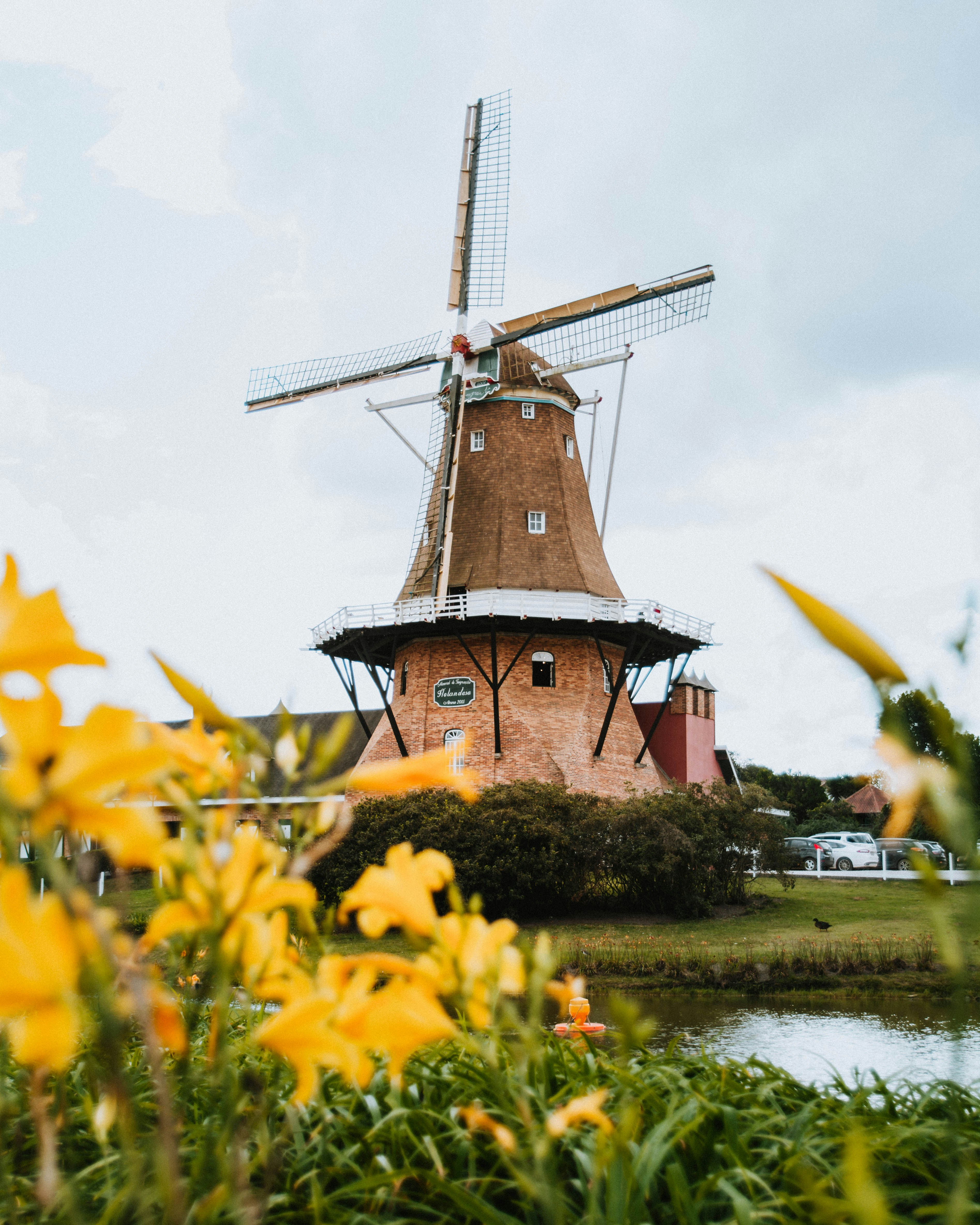 a windmill sitting next to a body of water