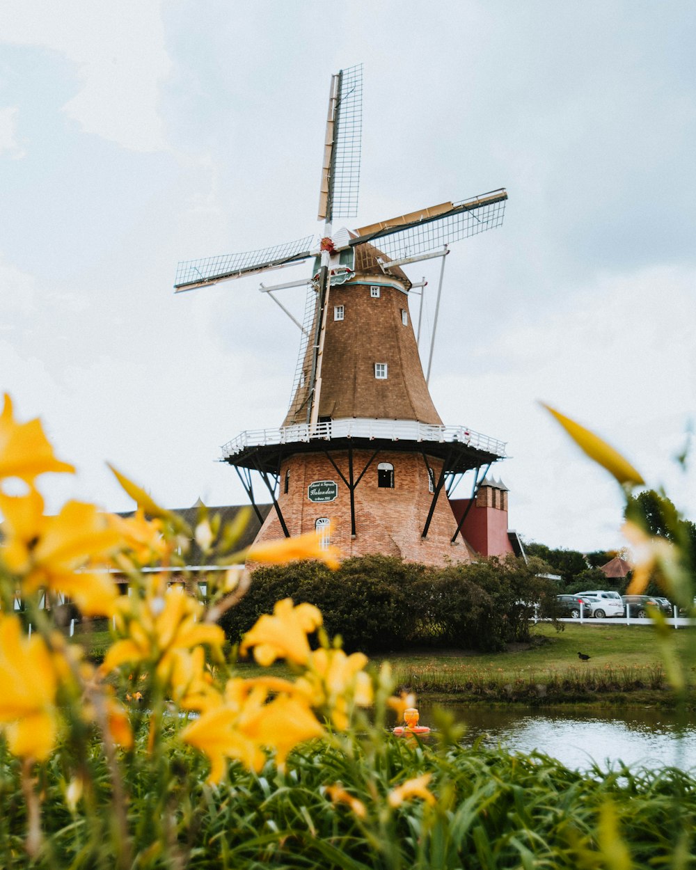 a windmill sitting next to a body of water