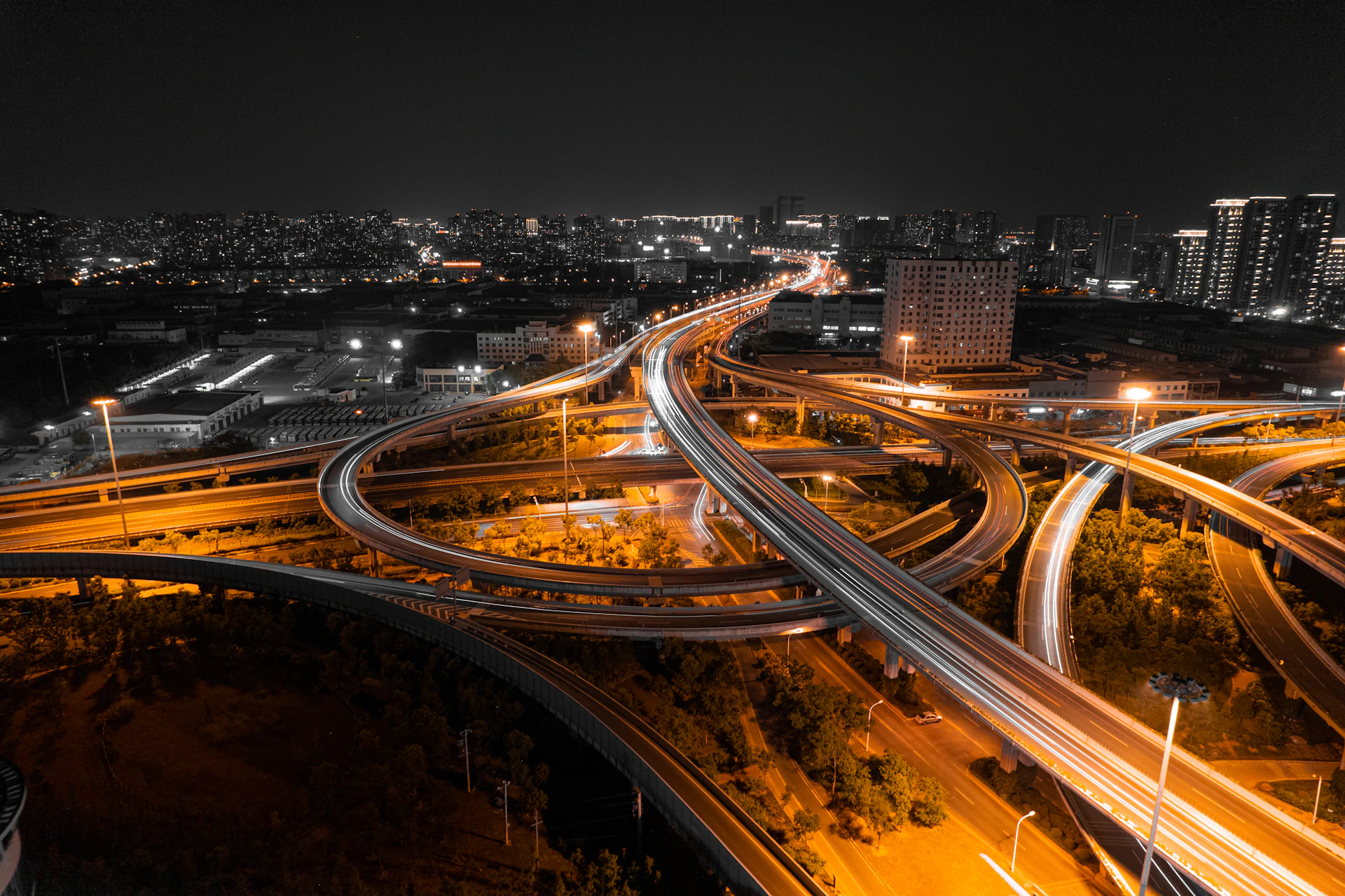 an aerial view of a highway intersection at night