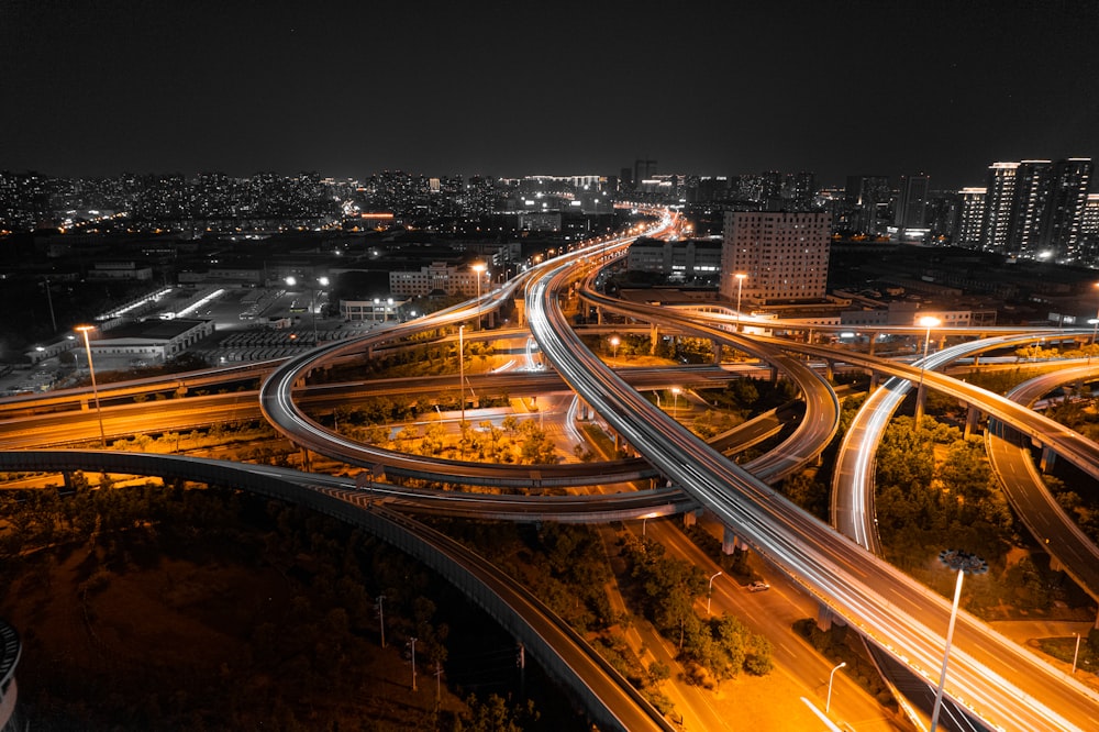 an aerial view of a highway intersection at night