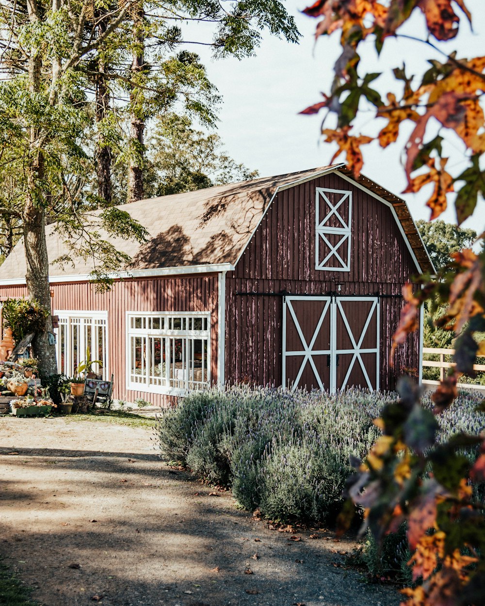 a red barn surrounded by trees and bushes
