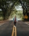 a man walking down the middle of a road