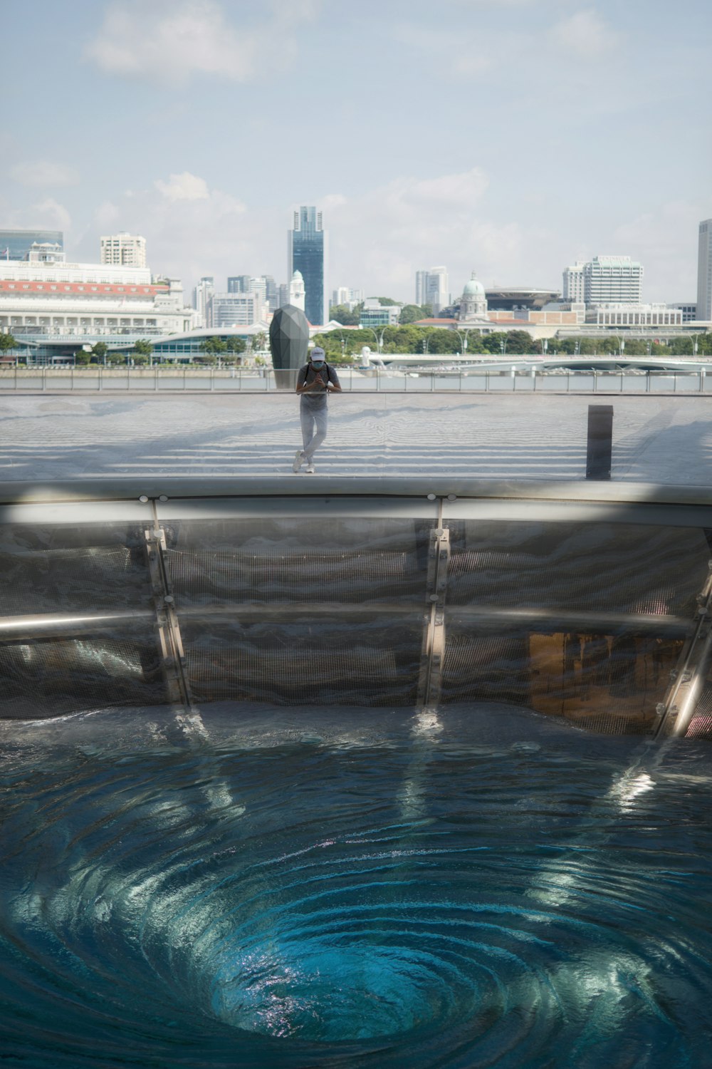 a man standing on top of a roof next to a pool of water