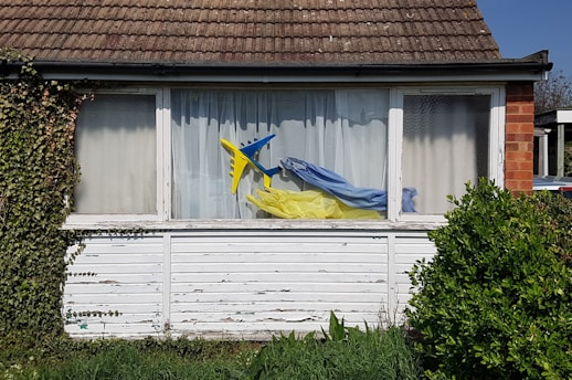 a window with a blue and yellow kite in it