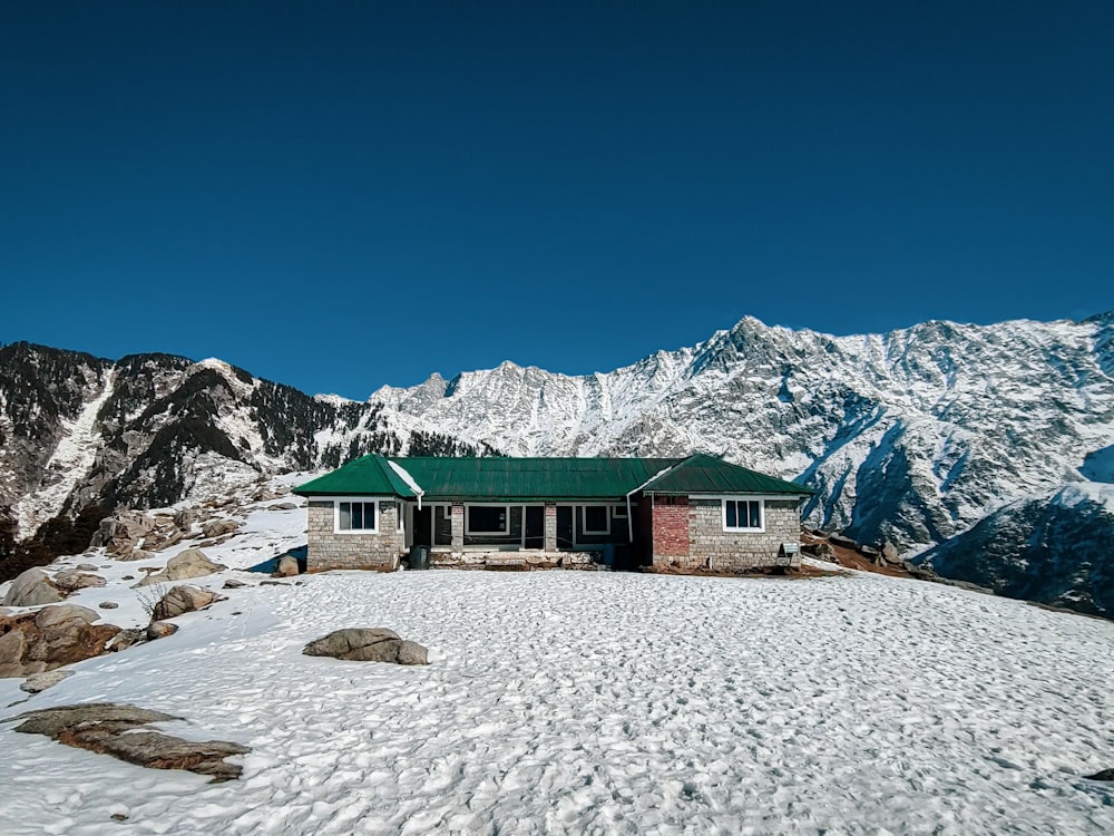 a house on top of a snow covered mountain