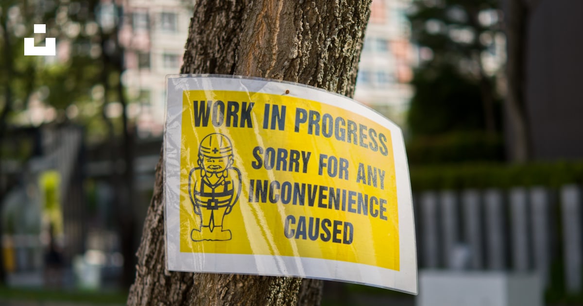 A work in progress sign attached to a tree photo – Free Work in process ...