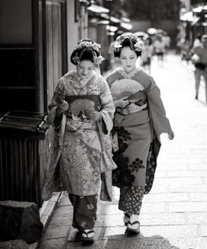 a couple of women walking down a street next to each other