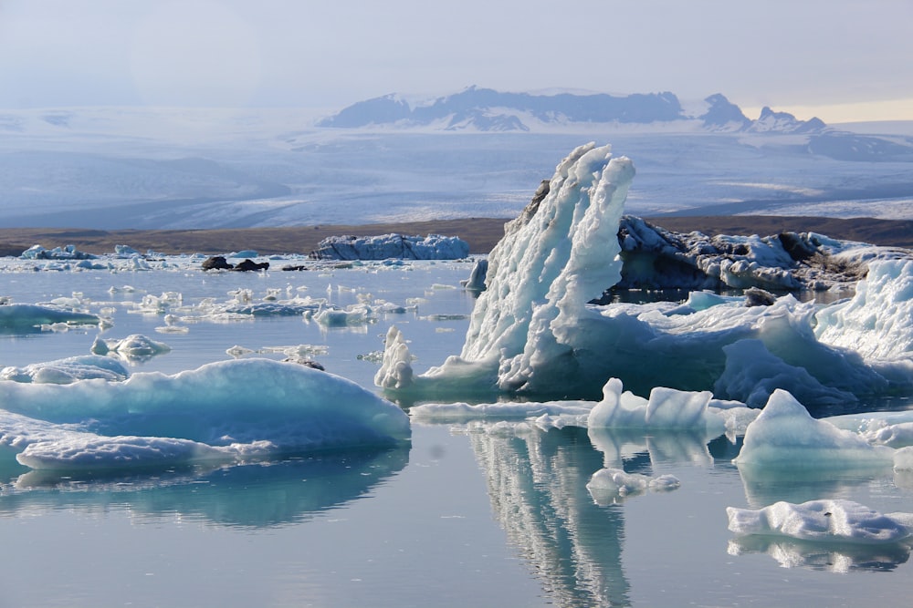 a group of icebergs floating on top of a body of water