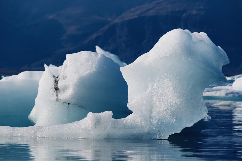 a large iceberg floating on top of a body of water