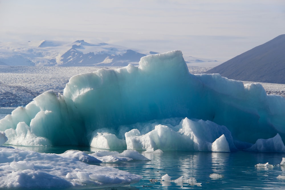 a large iceberg in the middle of a body of water