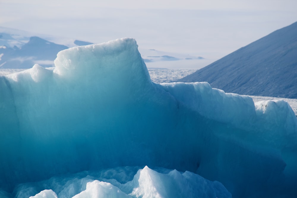 a large iceberg floating on top of a body of water