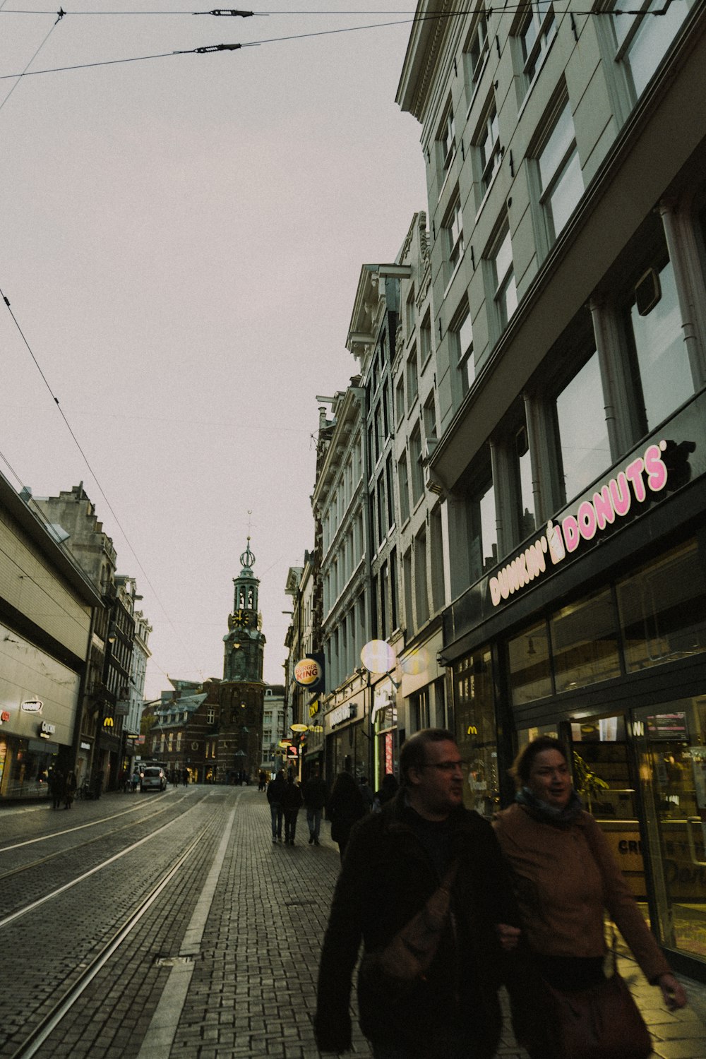 a couple of people that are walking down a street