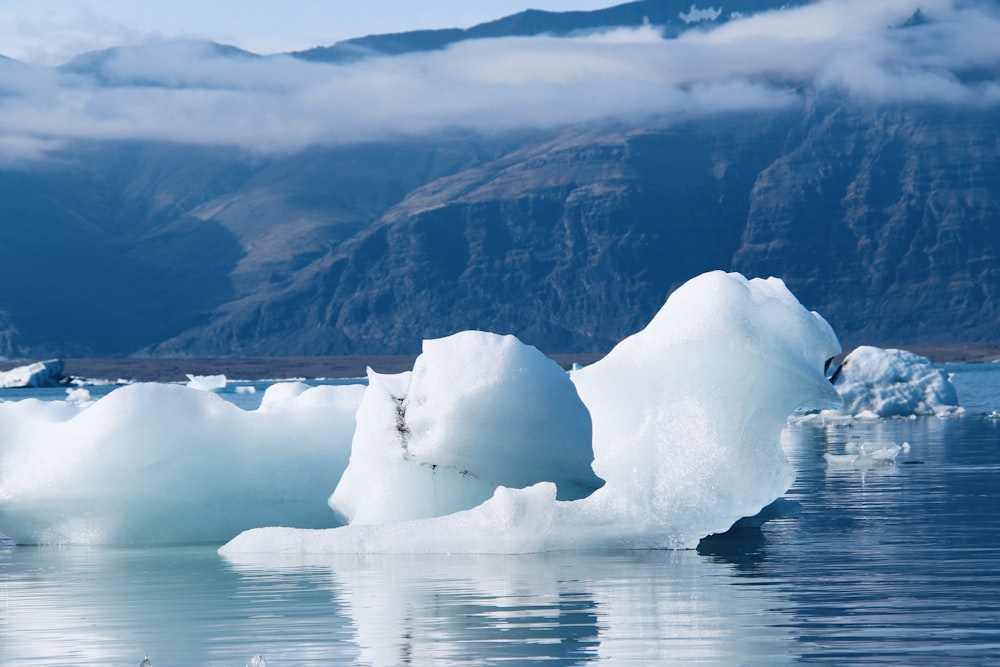 a large iceberg floating on top of a body of water