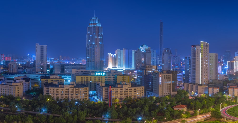 a city at night with a lot of tall buildings