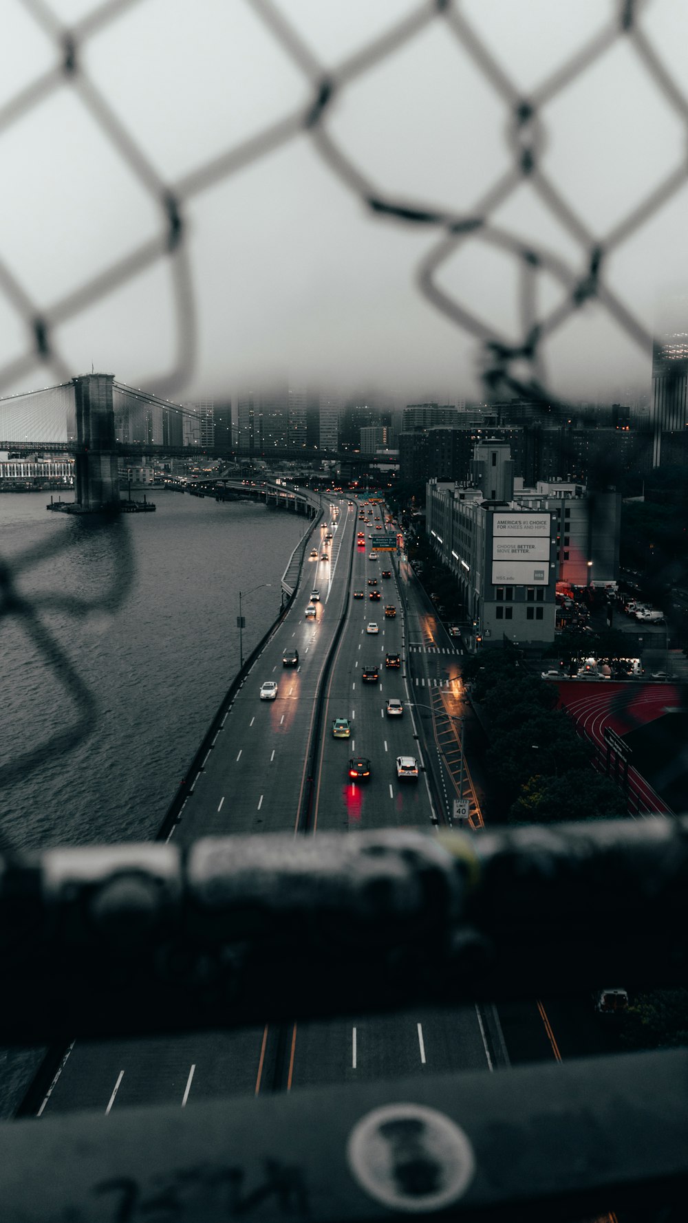 a view of a highway through a fence