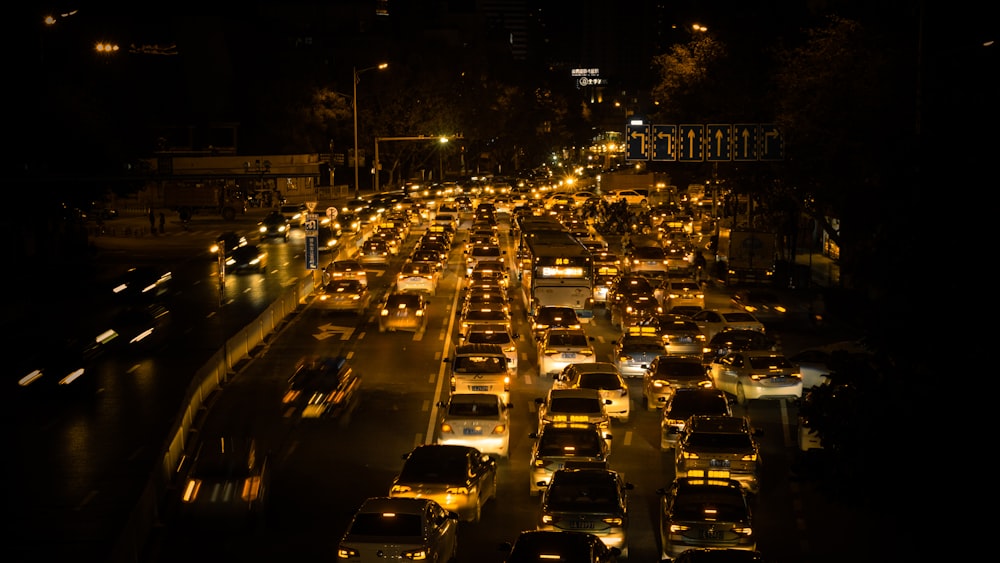 a city street filled with lots of traffic at night