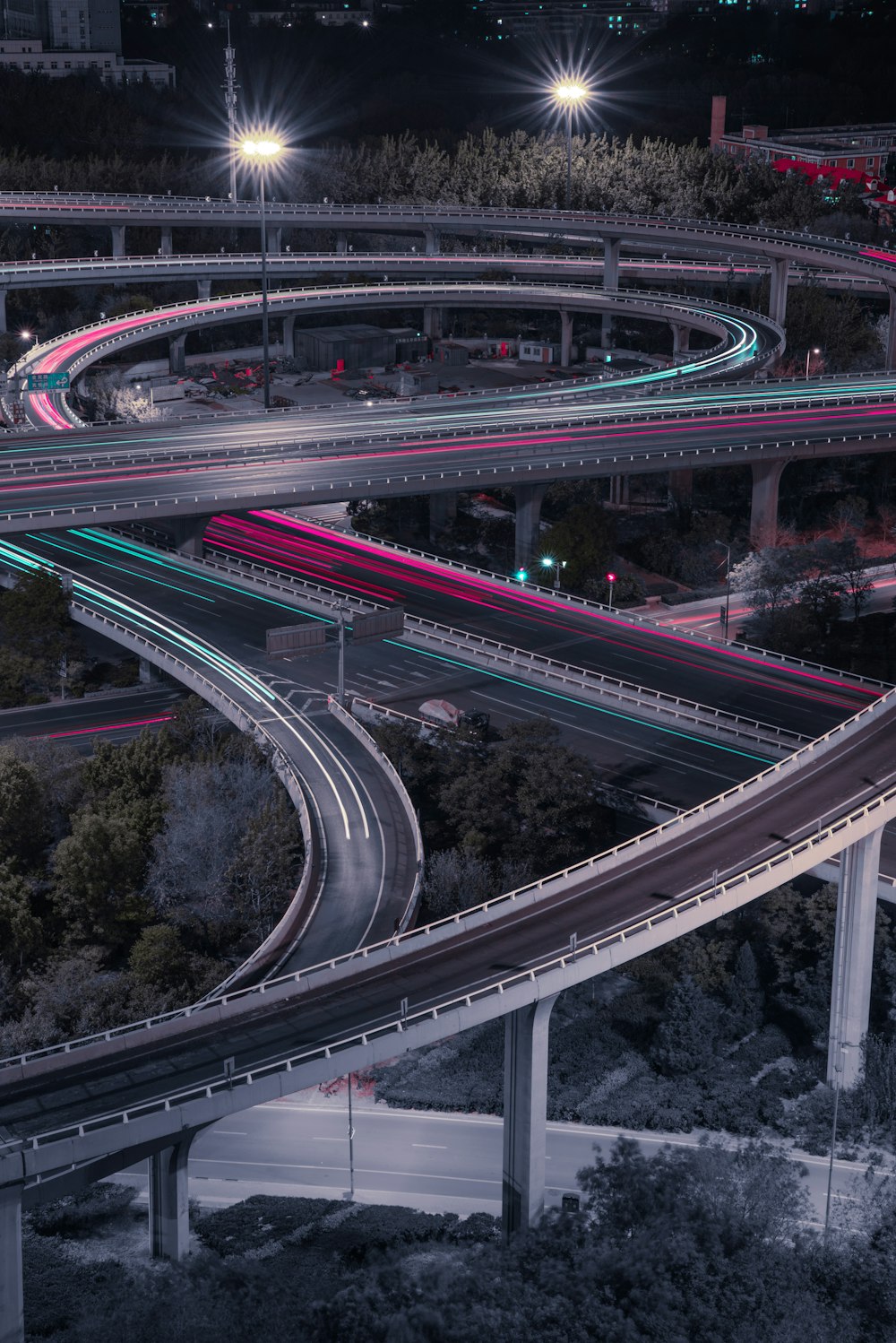 an aerial view of a highway intersection at night