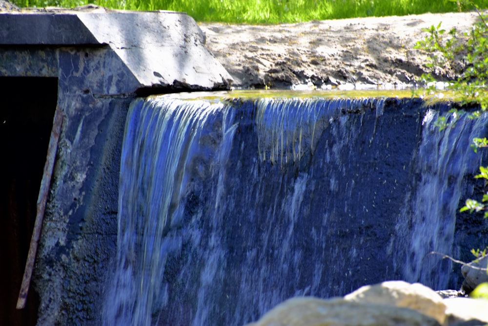 a small waterfall with water coming out of it