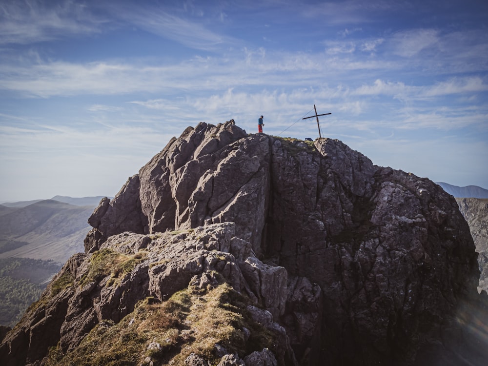 a person standing on top of a large rock