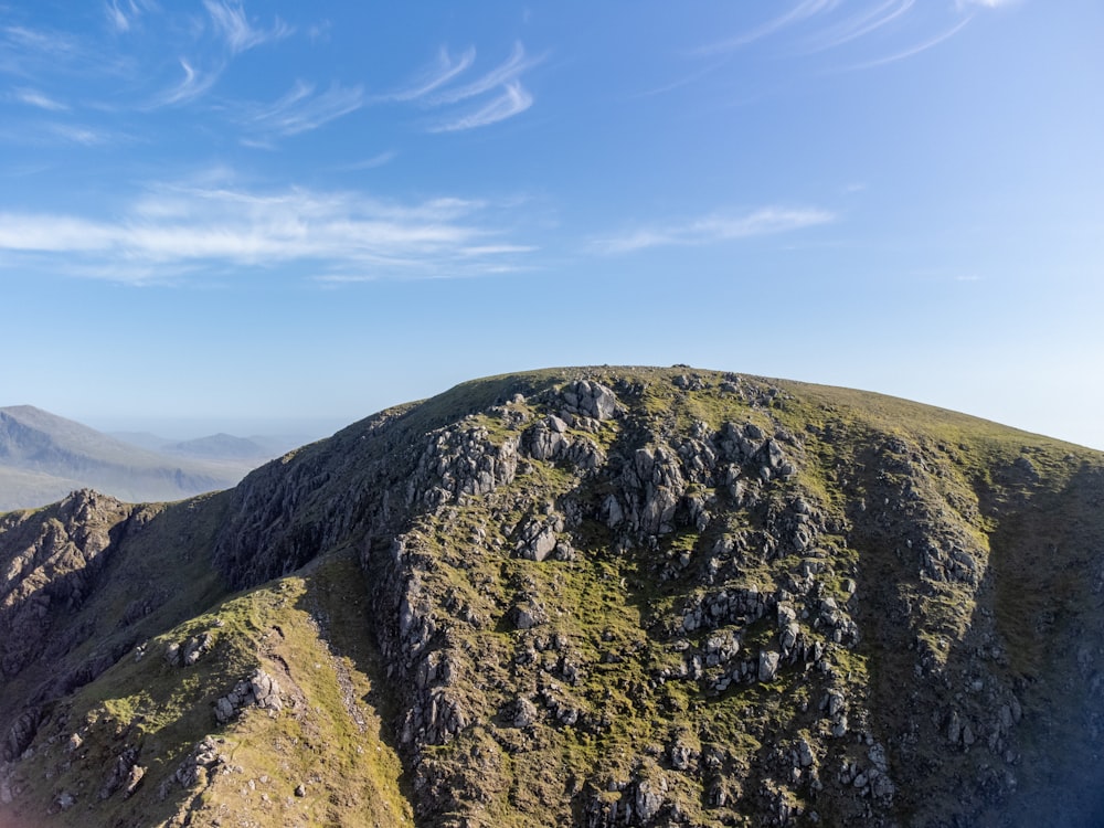 a view of the top of a mountain with a sky background