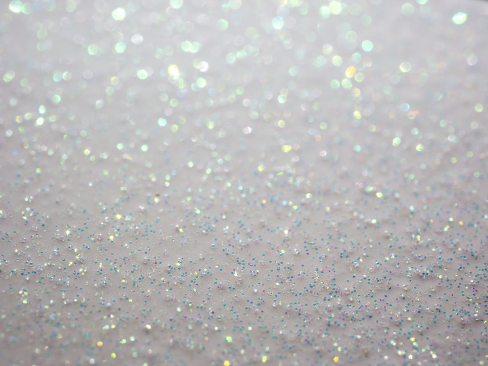 a close up of a white surface with glitter