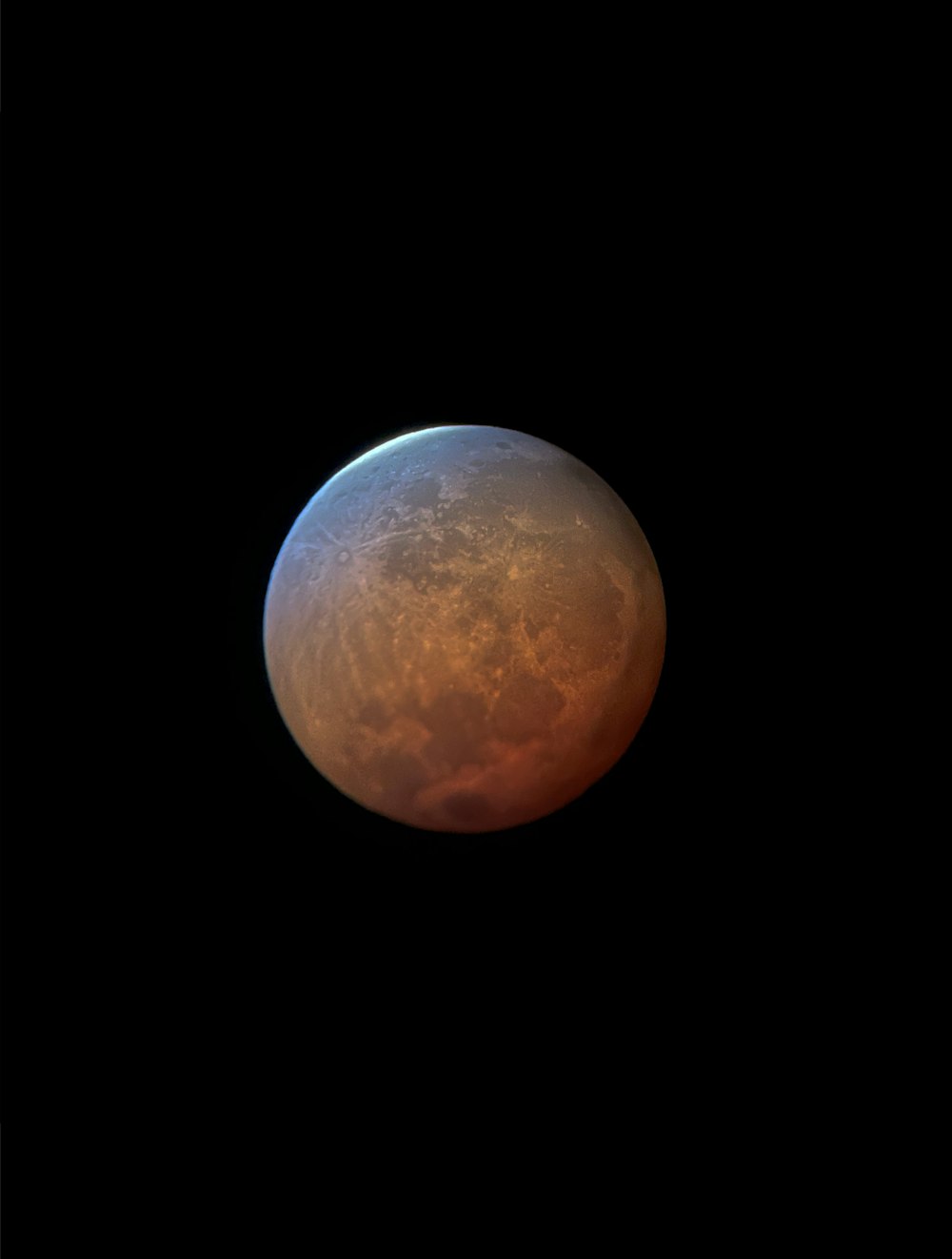 a red moon in the sky with a black background