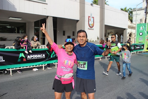 Smiling participants crossing a finish line together.