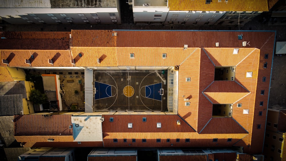 an aerial view of a building with a basketball court