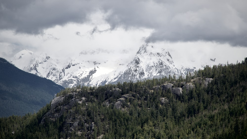 a mountain range with snow covered mountains in the background