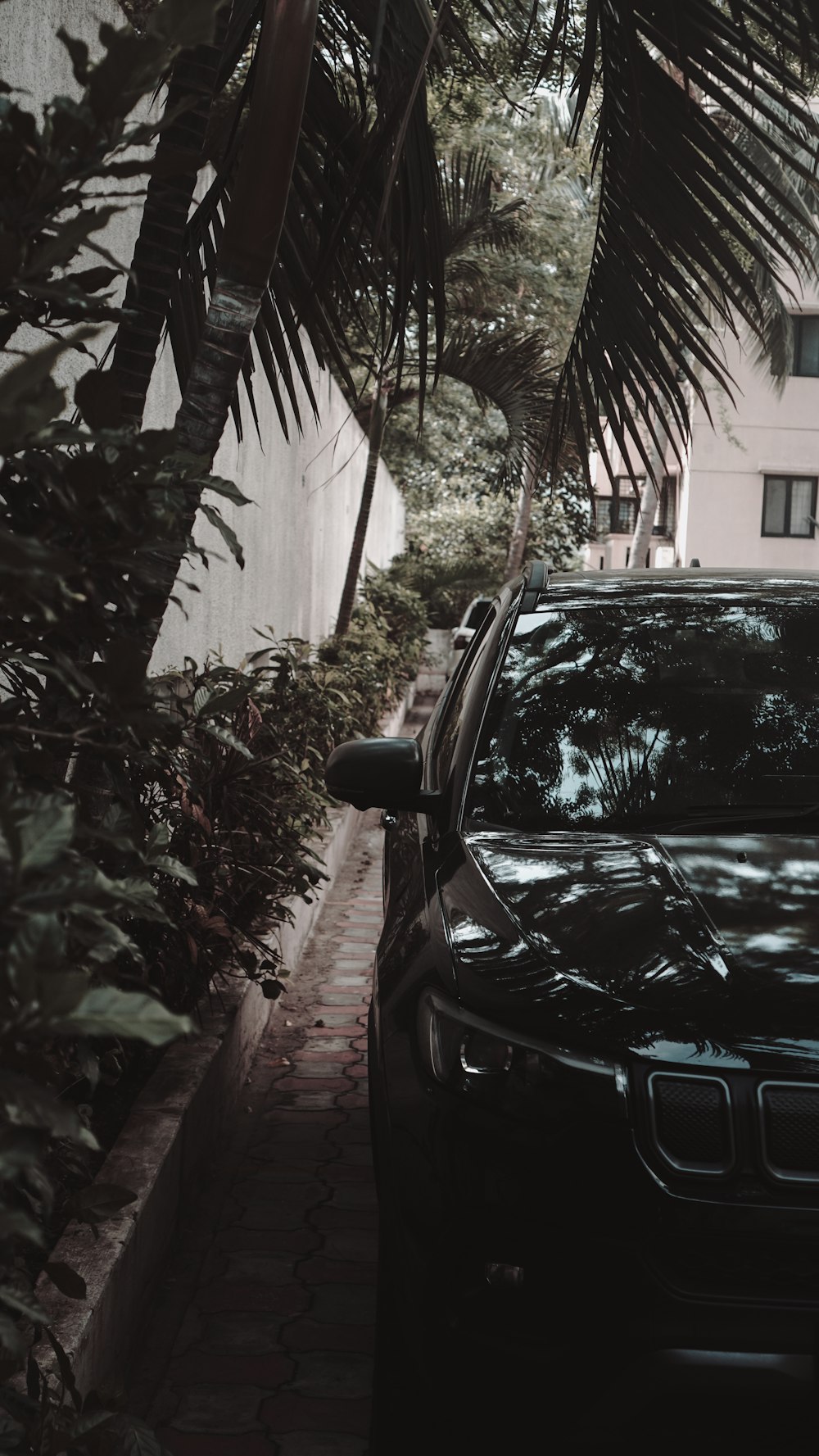 a black car parked on the side of a street