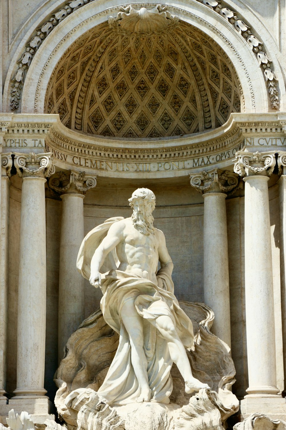 a statue of a man sitting on top of a fountain