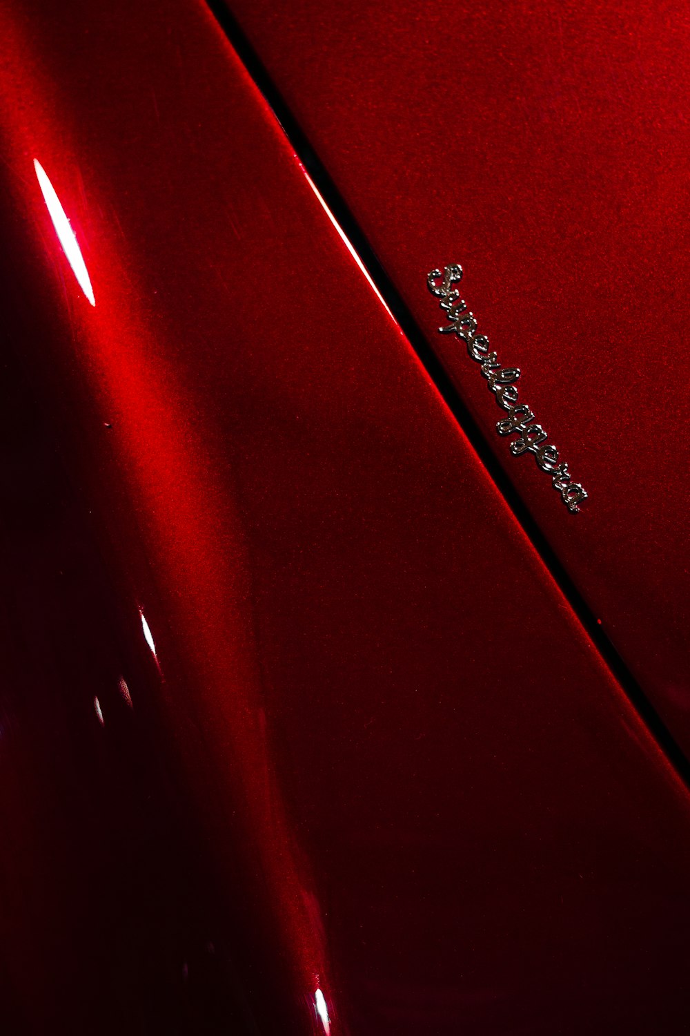 a close up of the emblem on a red car