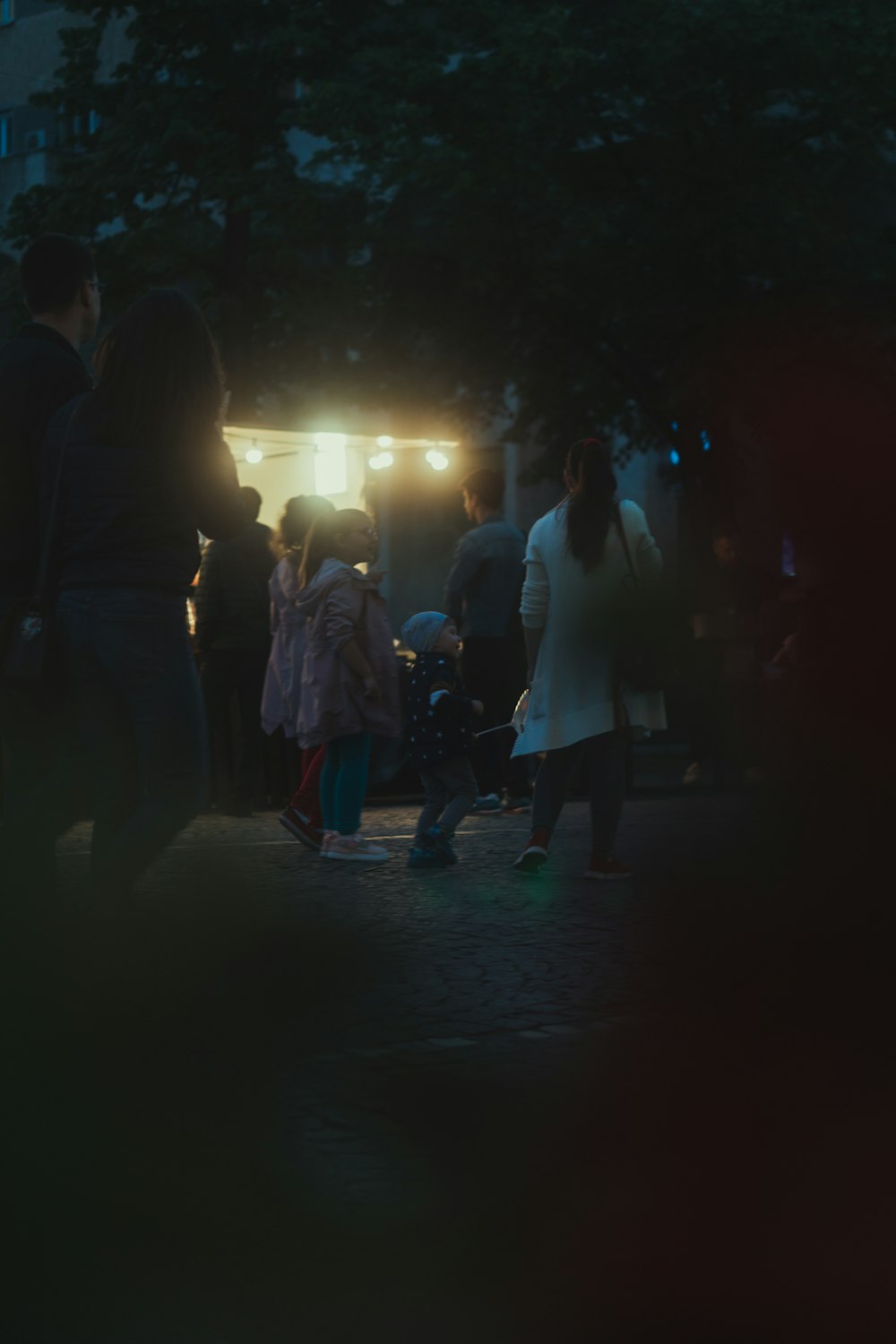 a group of people standing around in the dark