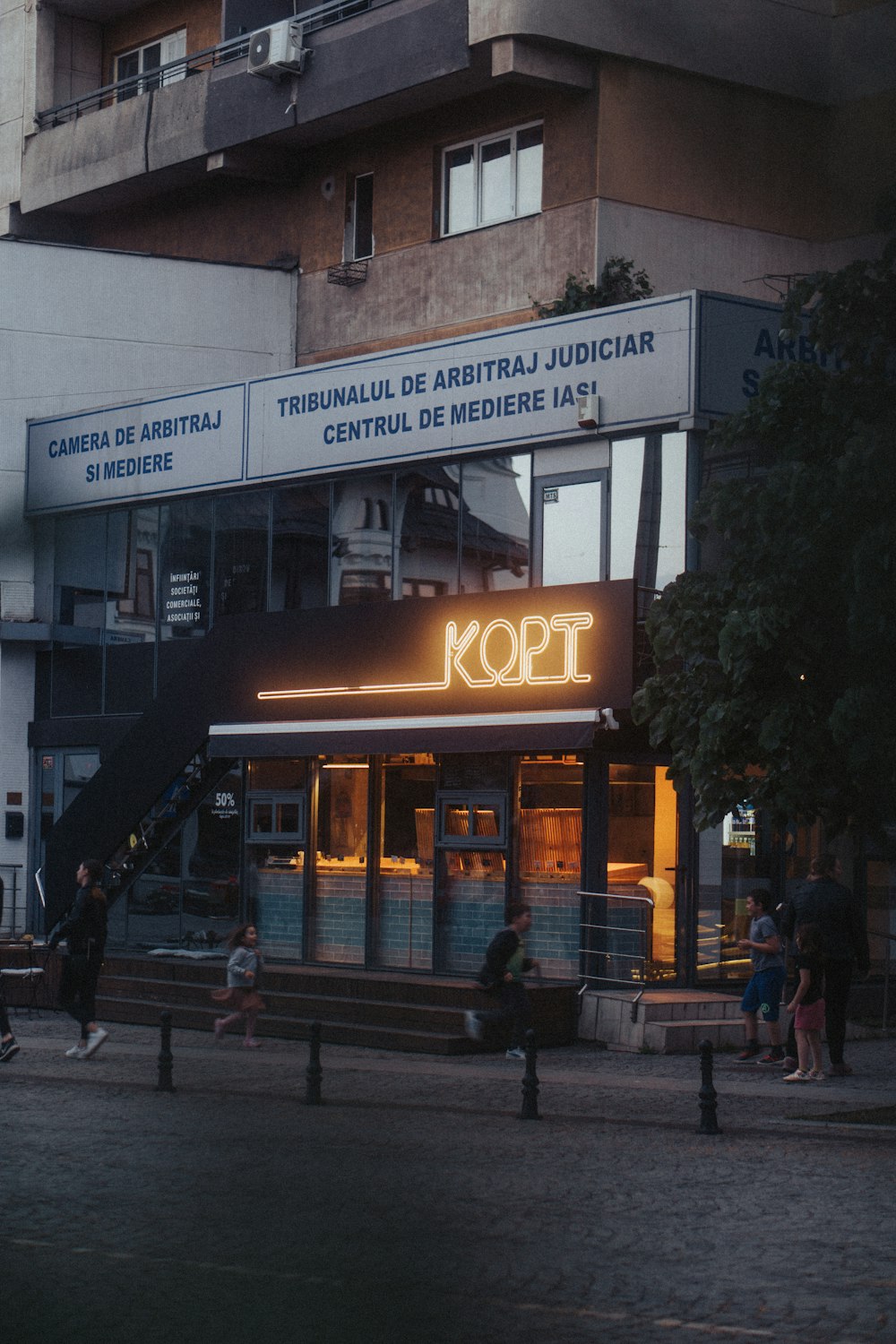 a group of people standing outside of a building