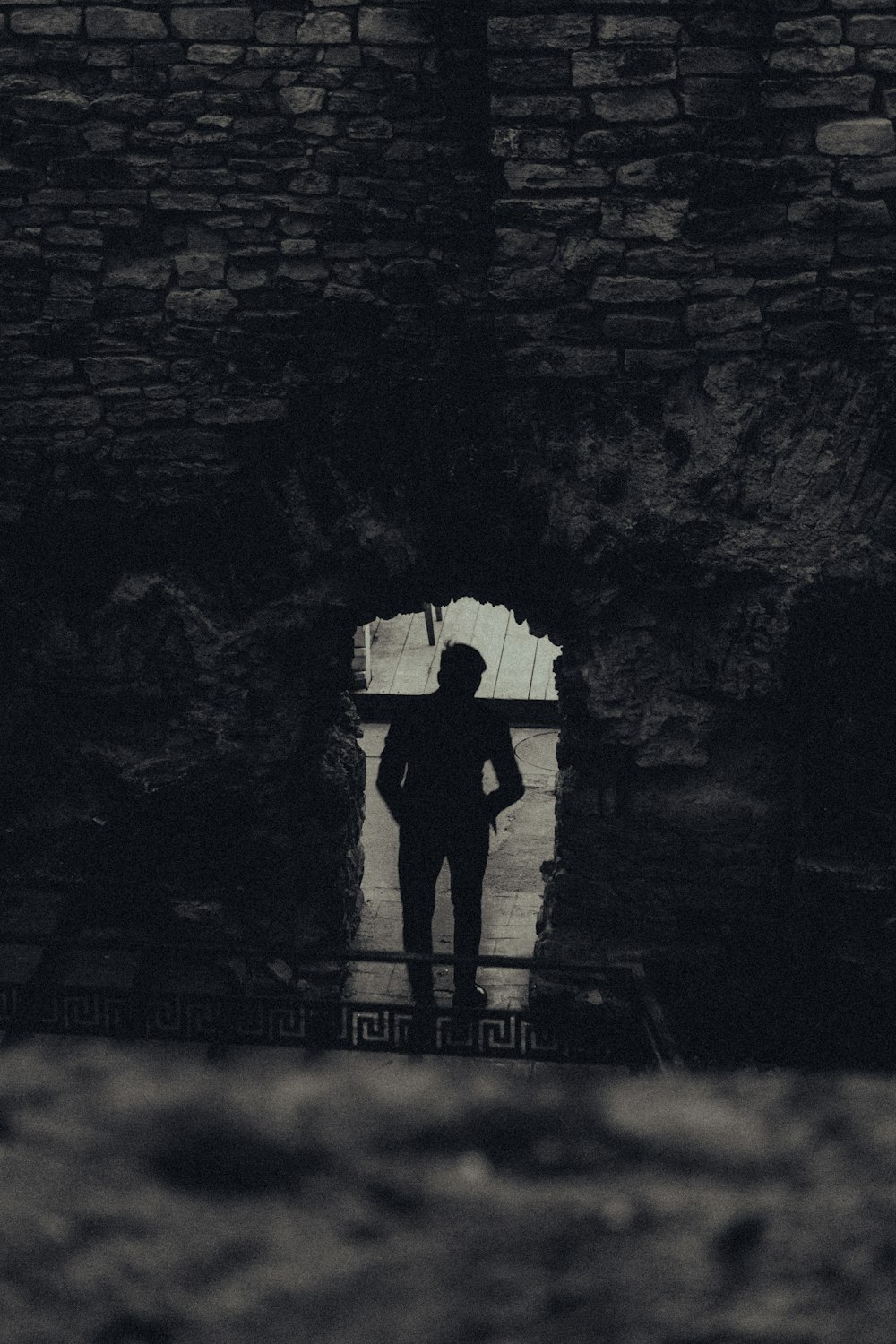 a person standing in a doorway with an umbrella