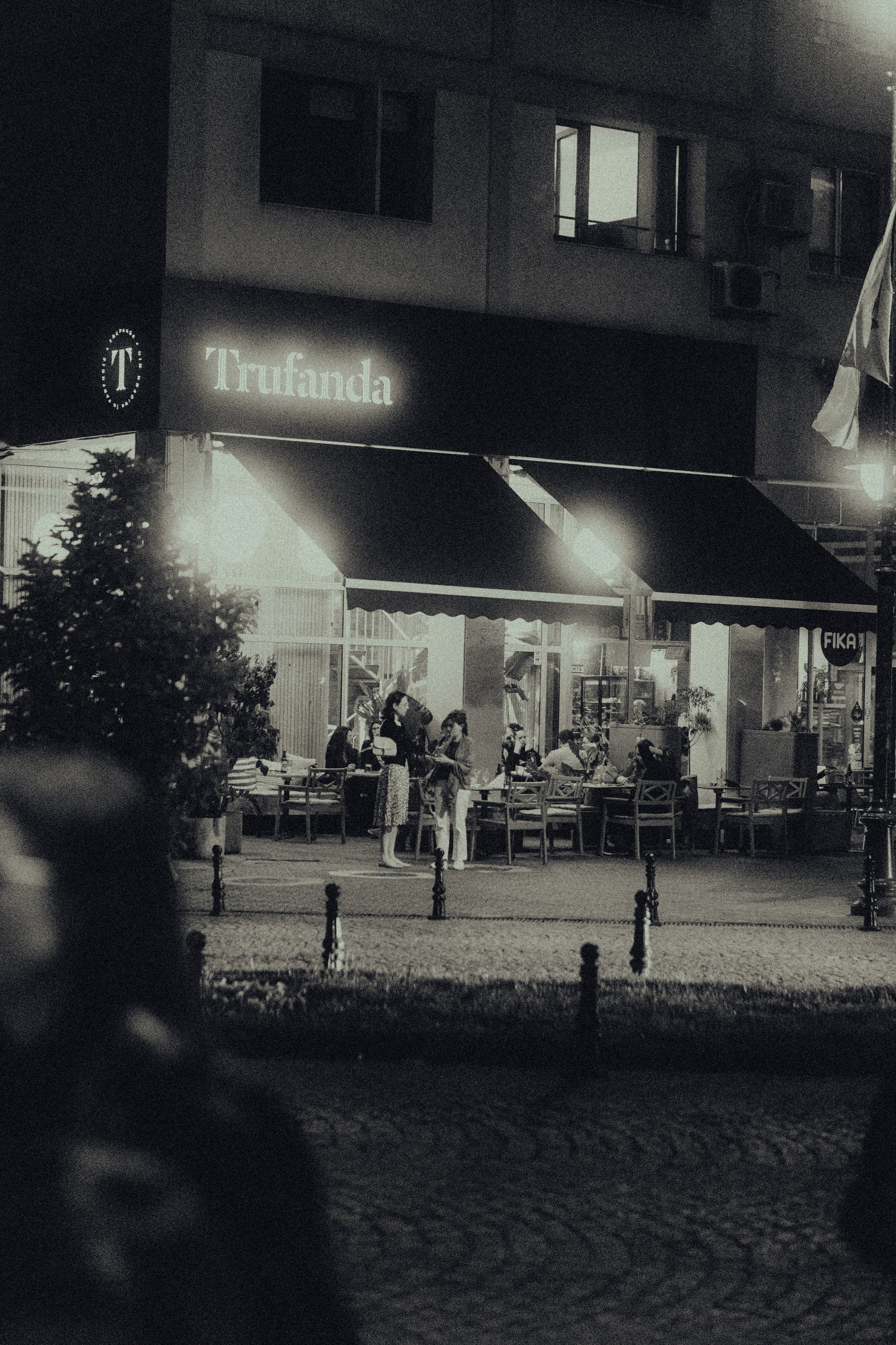 a black and white photo of a restaurant at night