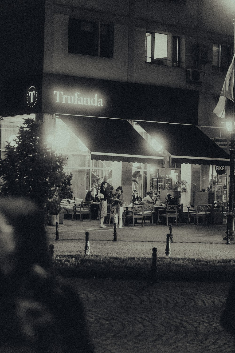 a black and white photo of a restaurant at night