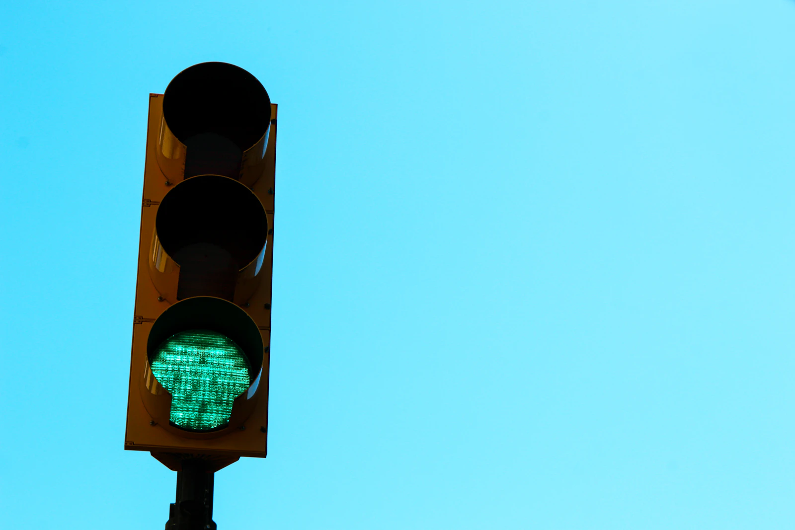 A traffic light showing a green signal against the sky, representing the pass or block verdict a direct crawler test reveals
